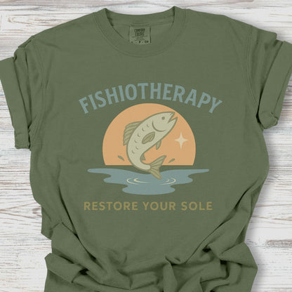 Green t-shirt with 'Fishiotherapy' graphic design on a wooden surface