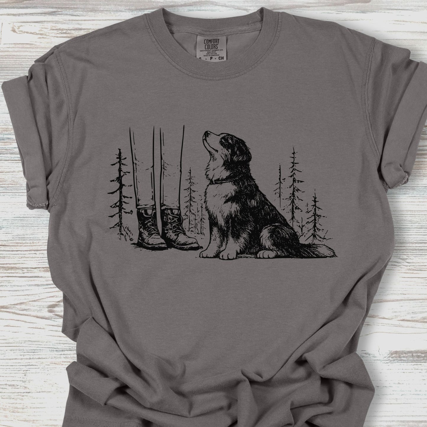 Gray t-shirt with a dog and nature graphic on a wooden surface
