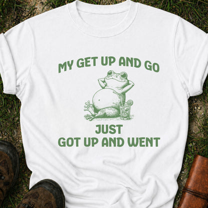 White t-shirt with green frog graphic and text on grass