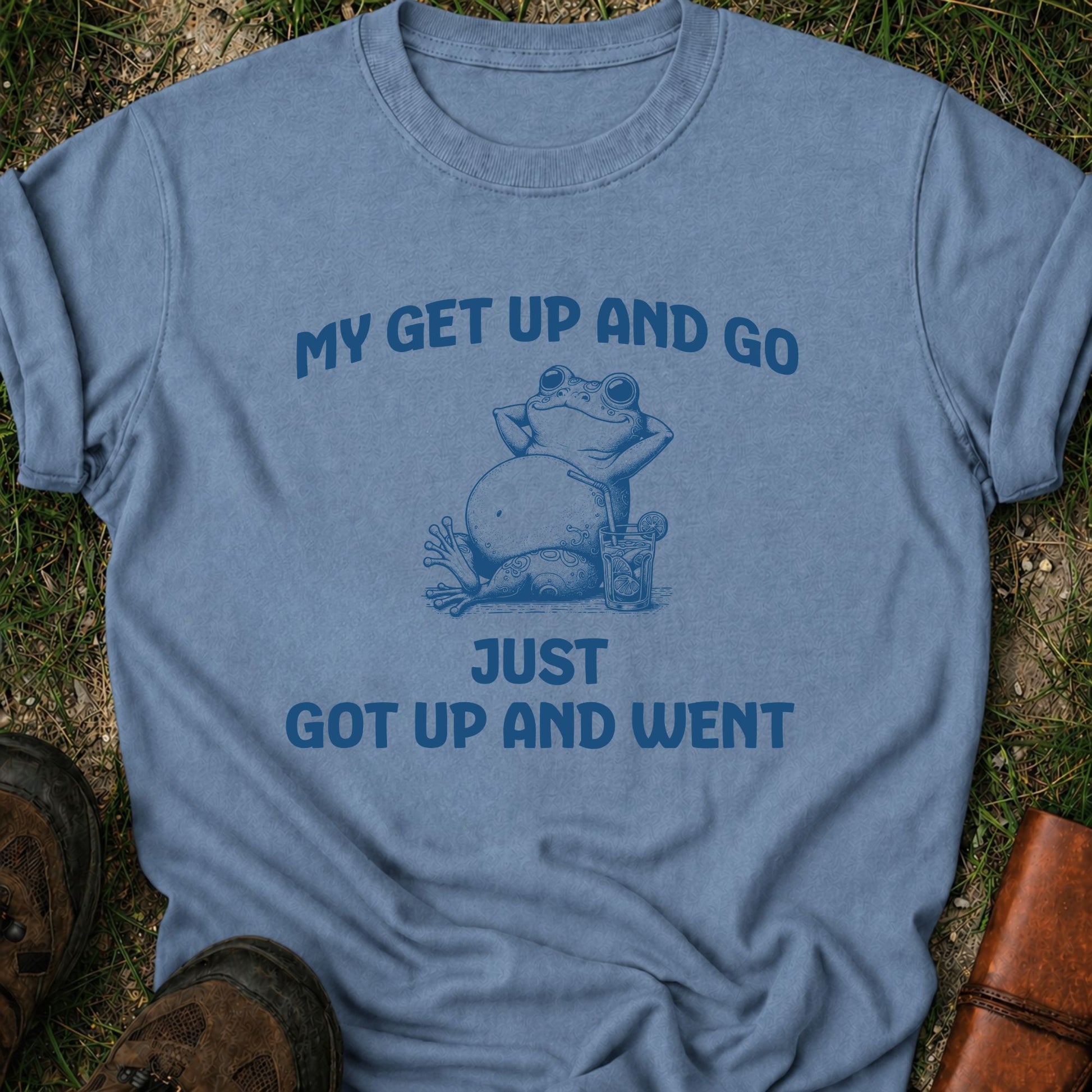 Blue t-shirt with a graphic of a frog and text on grass