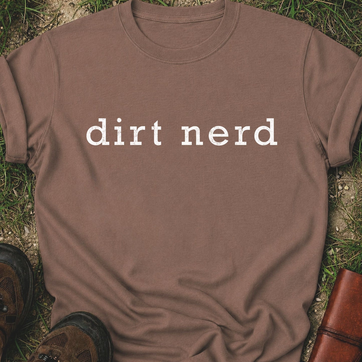 Brown t-shirt with 'dirt nerd' text on grass