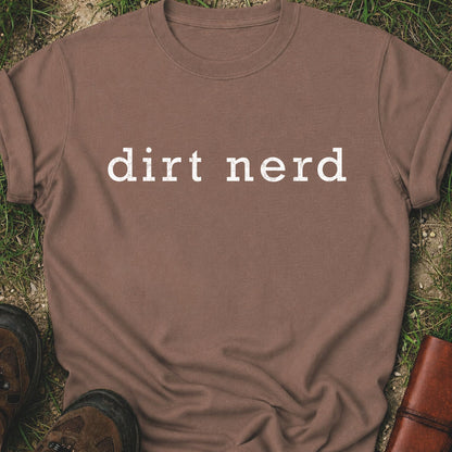 Brown t-shirt with 'dirt nerd' text on grass