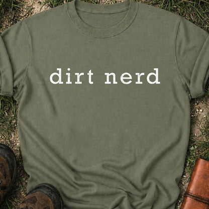Green t-shirt with 'dirt nerd' text on grass