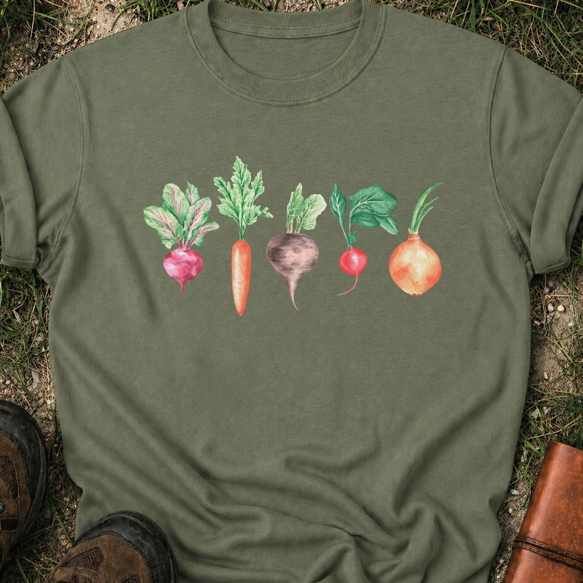 Moss Green  T-shirt with vegetable graphic laying flat  on a grassy surface