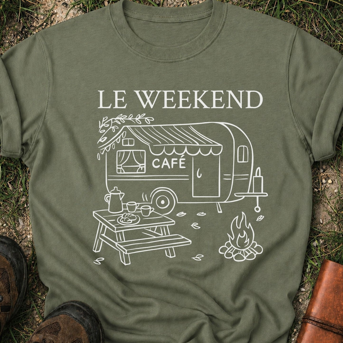 Green t-shirt with 'Le Weekend Cafe' design on grass