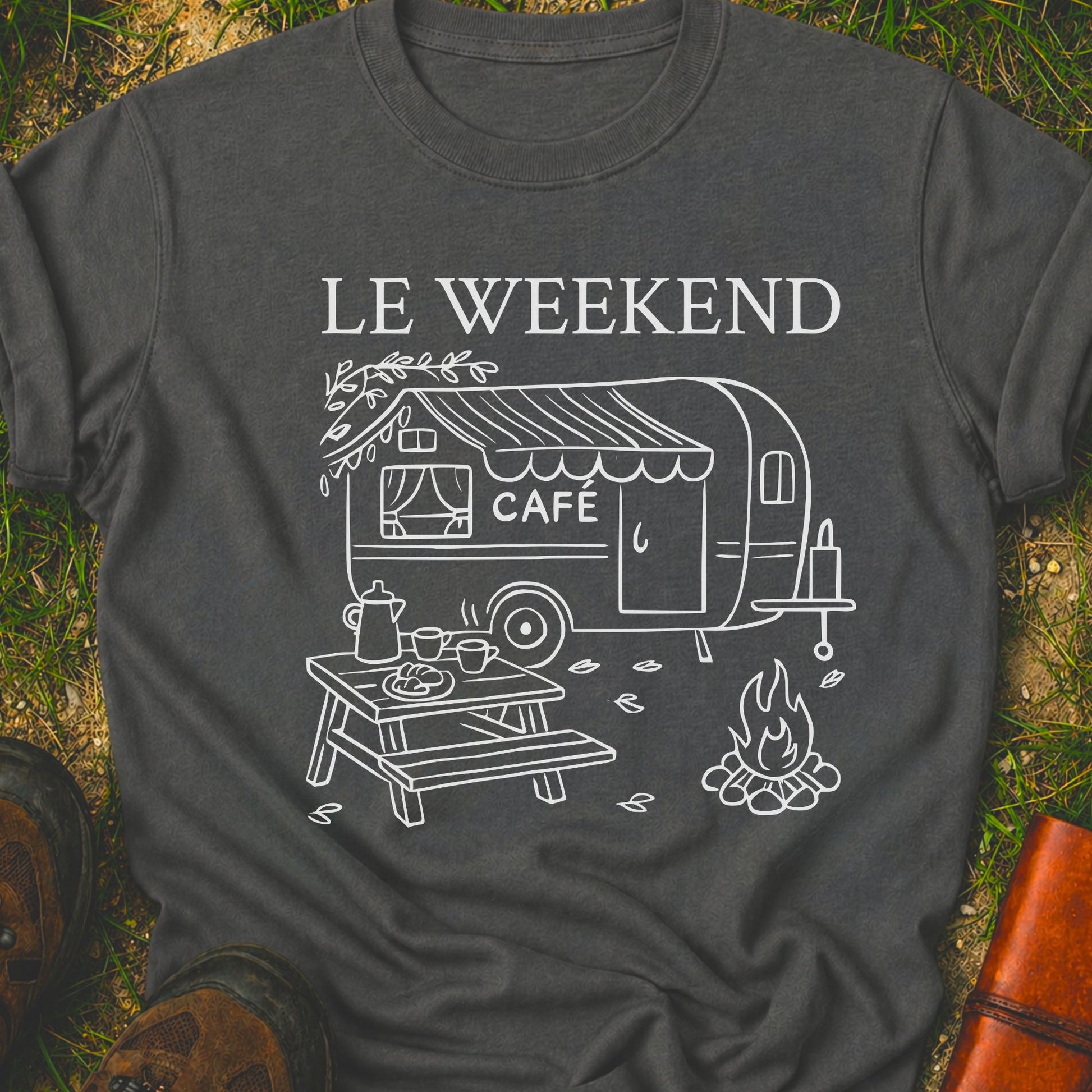 Dark gray t-shirt with 'Le Weekend Café' design featuring a caravan and camping scene on grass.
