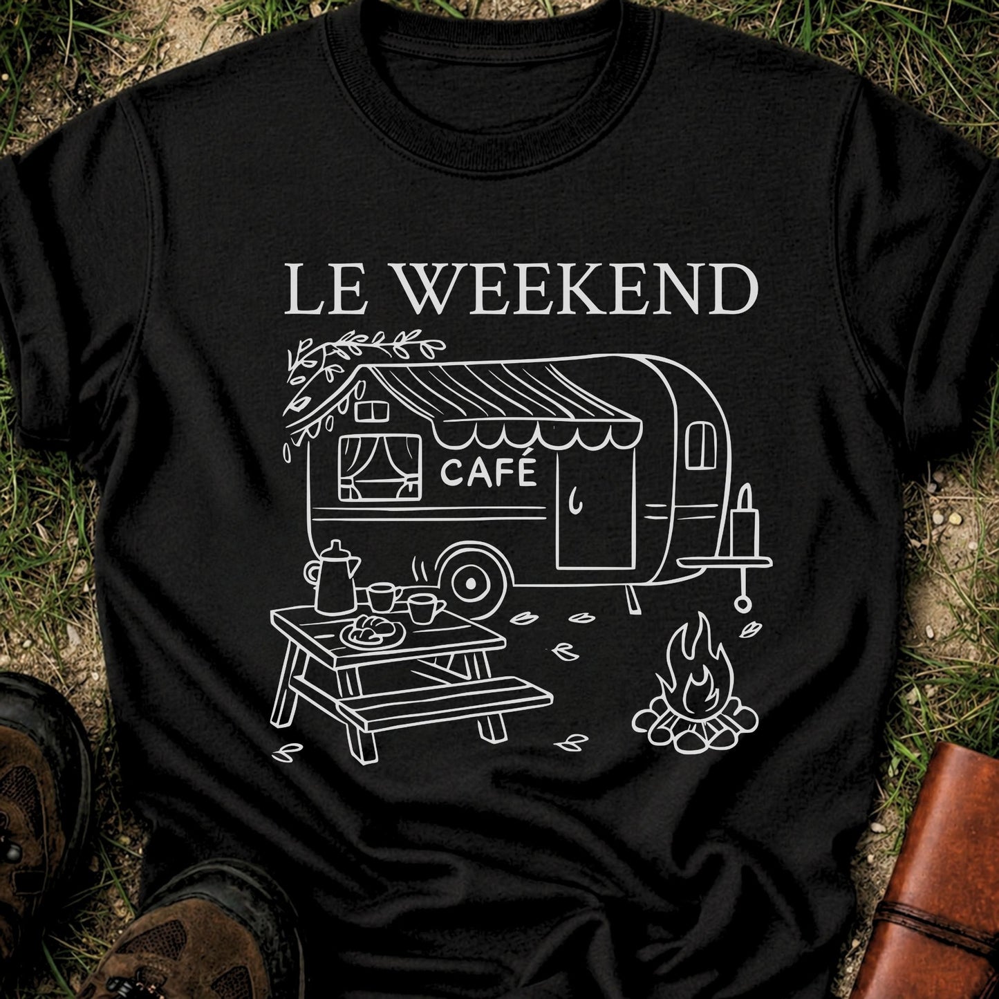 Black t-shirt with 'Le Weekend Café' design featuring a caravan and outdoor setup on grass.