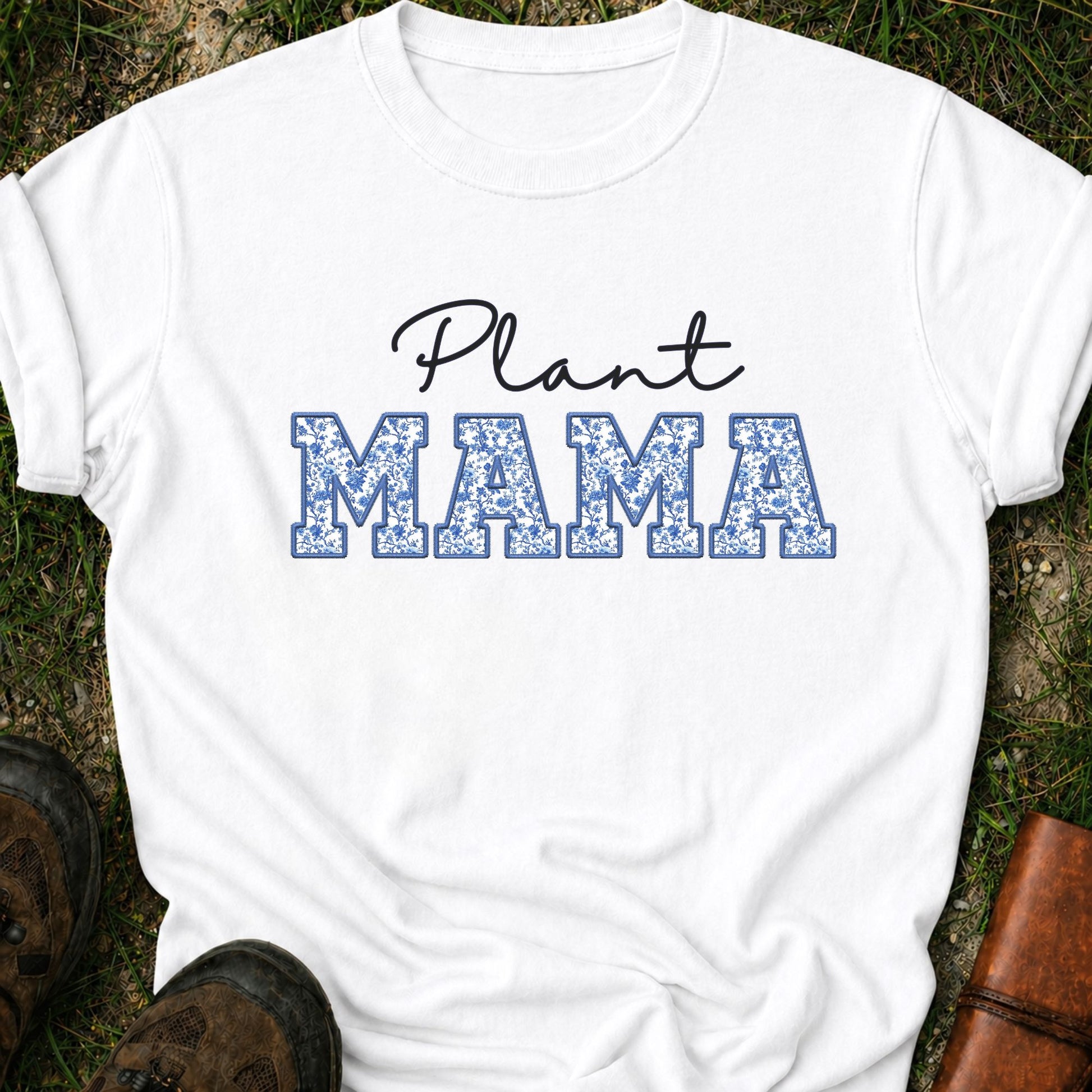White  t-shirt with 'Plant MAMA' text on a grass surface