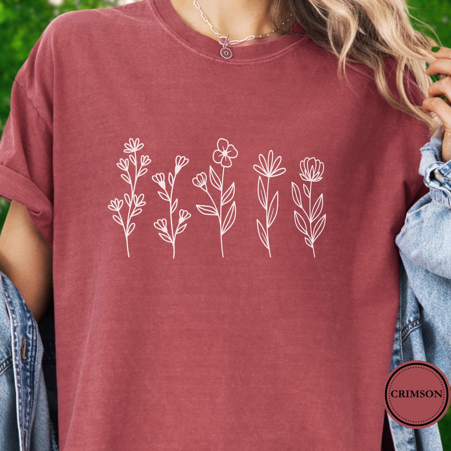 Model Wearing a dark pink t-shirt with white floral designs 