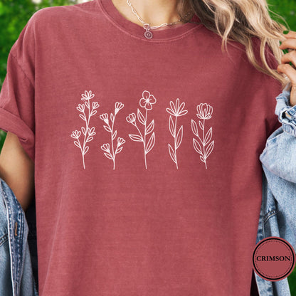 Model Wearing a dark pink t-shirt with white floral designs 