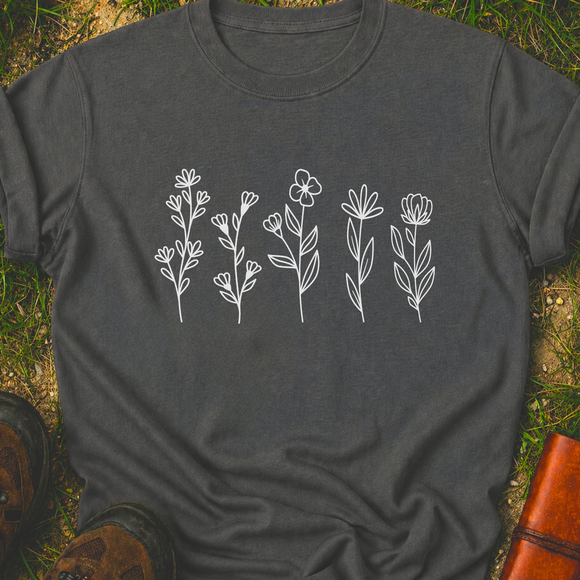 Dark gray t-shirt with white floral designs on grass