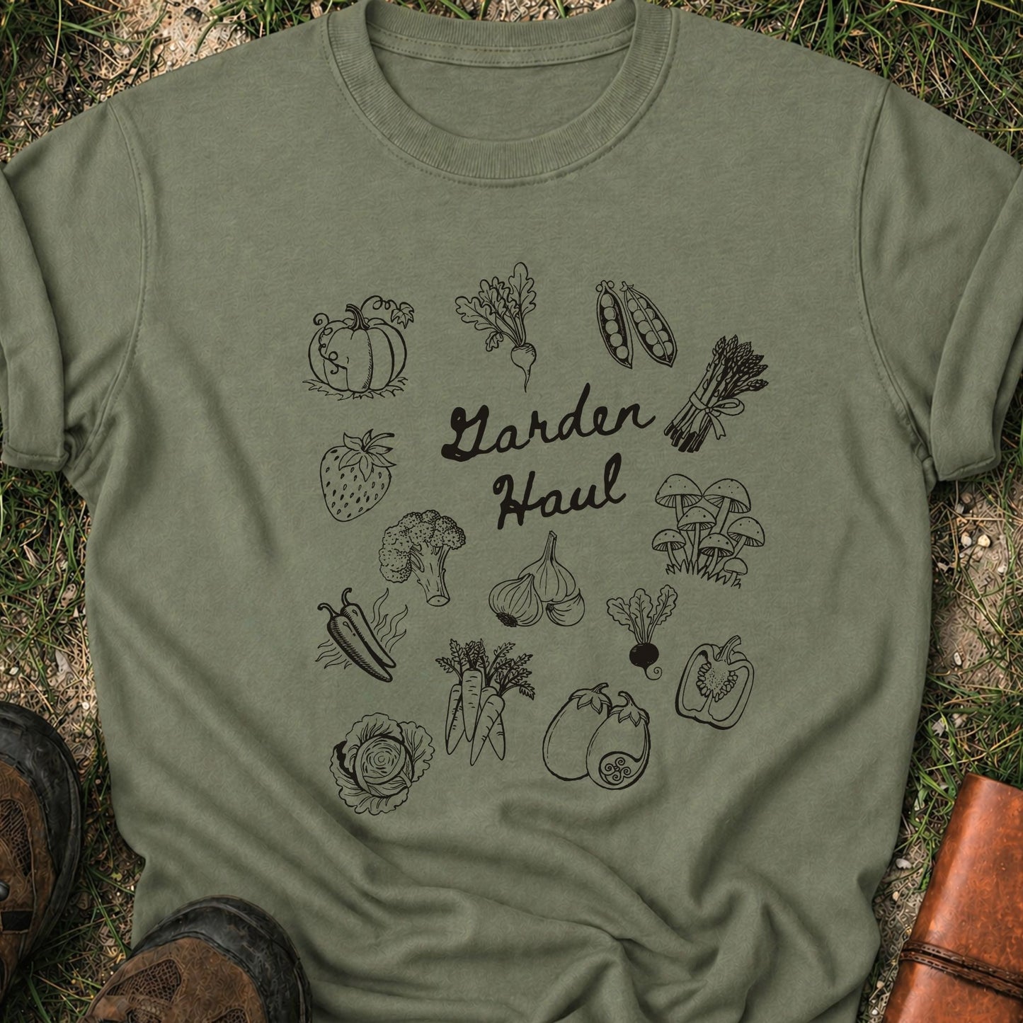 Green t-shirt with vegetable illustrations and 'Garden Haul' text on grass