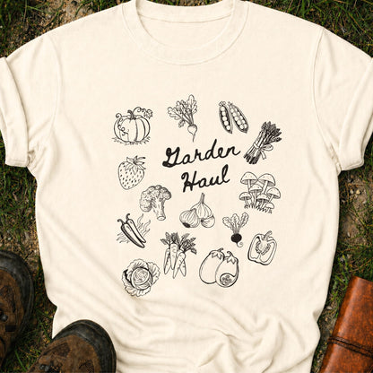 Ivory t-shirt with black vegetable illustrations and 'Garden Haul' text on grass