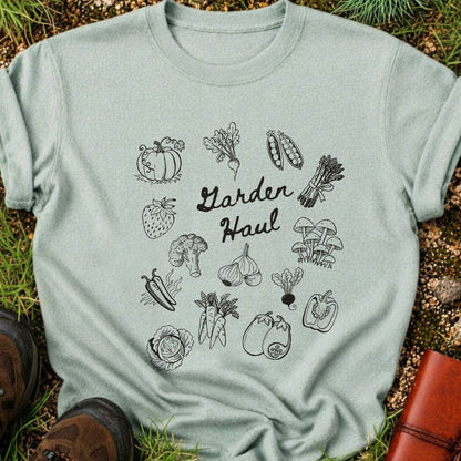 Light green t-shirt with black vegetable illustrations and 'Garden Haul' text on grass.