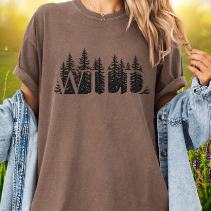 Model wears a brown t-shirt with the word WILD cut into a  forest design.