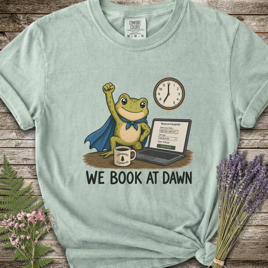Light Green T-shirt with the image of a frod with his fist raised in front of a computer with the phrase "We Book At Dawn"