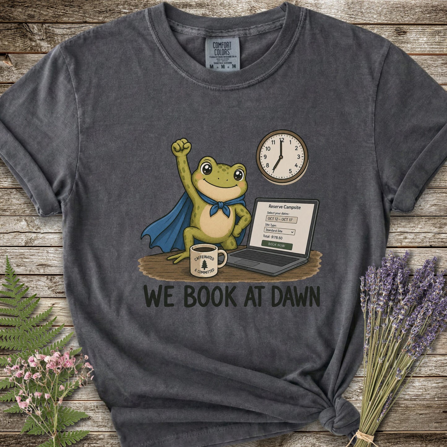 Dar Grey T-shirt with the image of a frod with his fist raised in front of a computer with the phrase "We Book At Dawn"