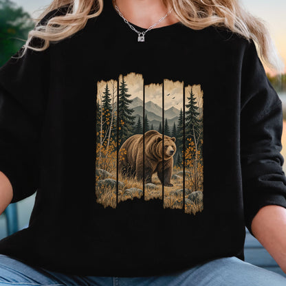A person wearing a black long-sleeve crewneck sweatshirt with a rustic vertical wood-panel graphic showing a brown grizzly bear in a forest with mountains in the background.