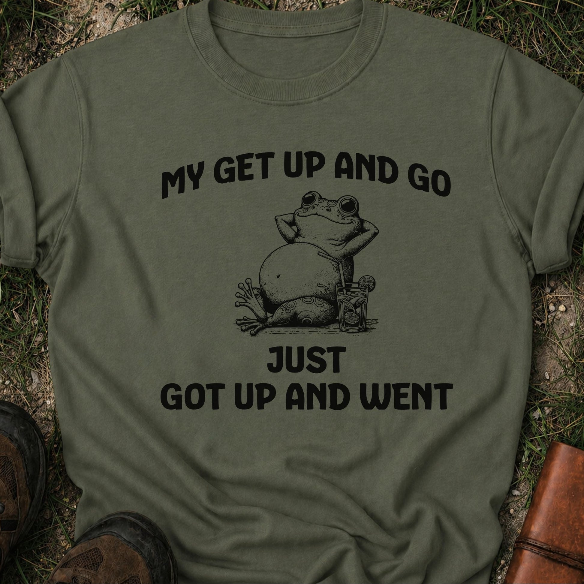Green t-shirt with a frog graphic and text on grass