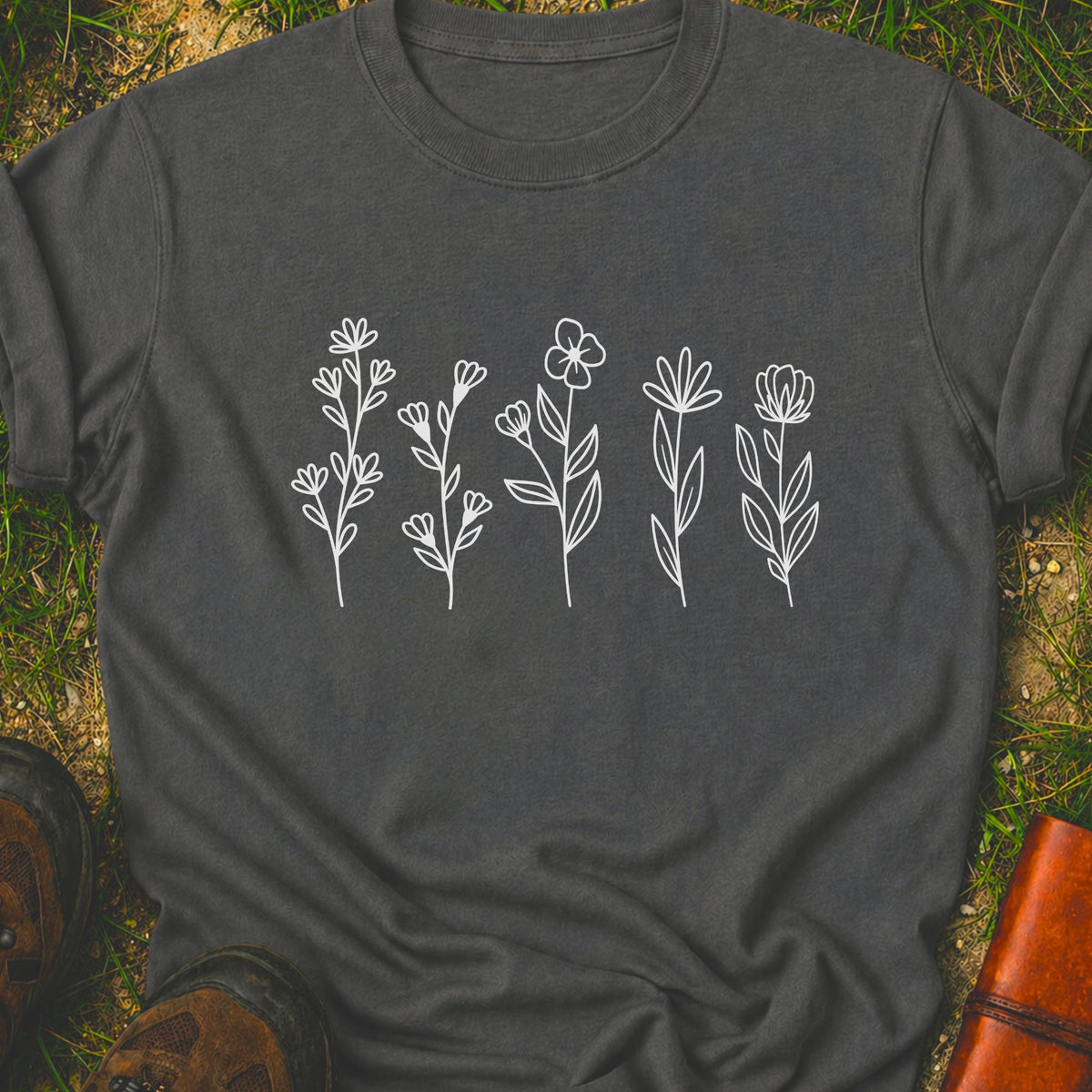 Dark gray t-shirt with white floral designs on grass
